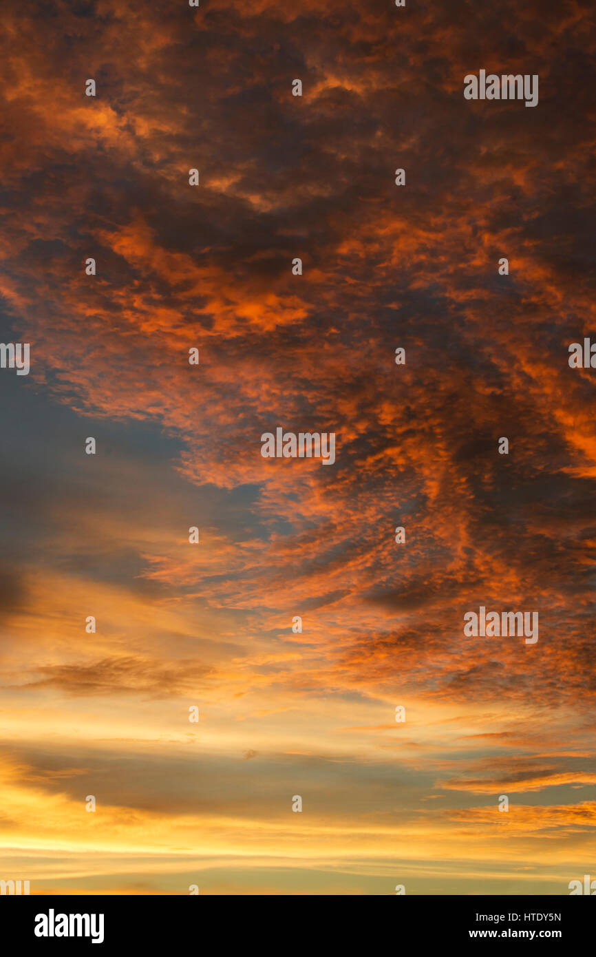 Sky filled with dark and light orange colored clouds during sunset ...