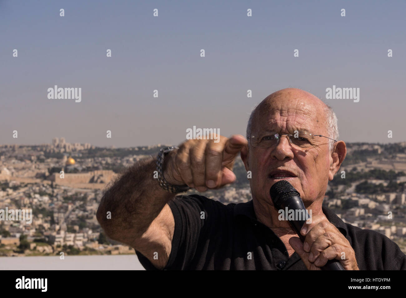 Yossi Langotzki, a former officer and a Geologist responsible for finding offshore natural gas reserves in Israel, speaks. Temple mount in background. Stock Photo