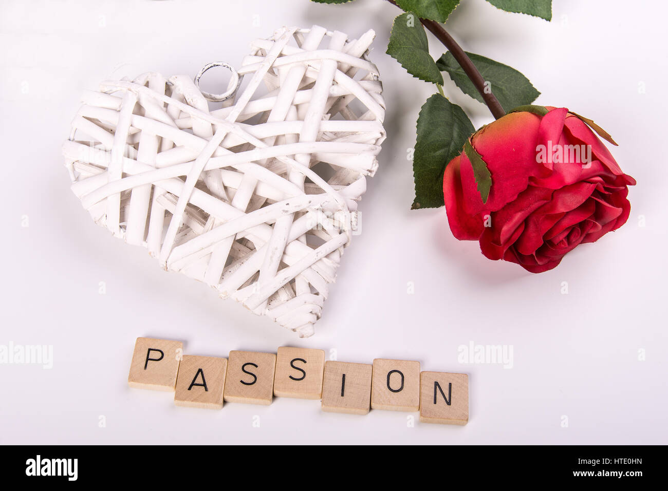 A red rose with a white heart and the word 'passion' Stock Photo