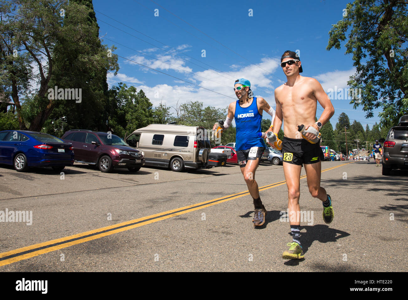 Ultra-marathon runner Paul Terranova (in blue shirt) and his pacer running in the Western States 100-mile Endurance Run.  Western States is one of the Stock Photo