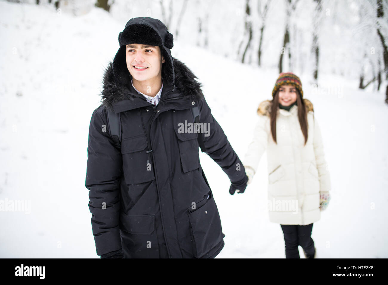 Happy Couple Having Fun Outdoors in Snow Park. Winter Vacation. Couple ...