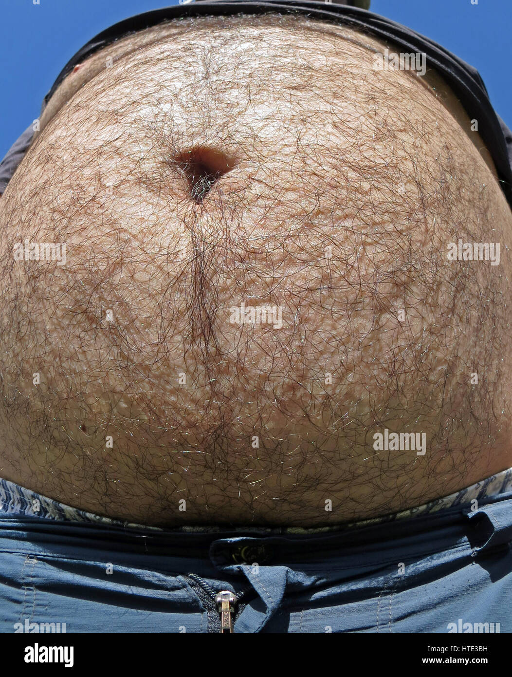 A fat man with a big belly Stock Photo