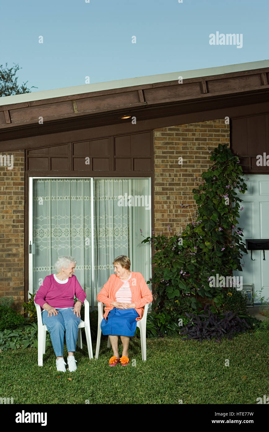 Two senior woman sitting in the garden Stock Photo - Alamy