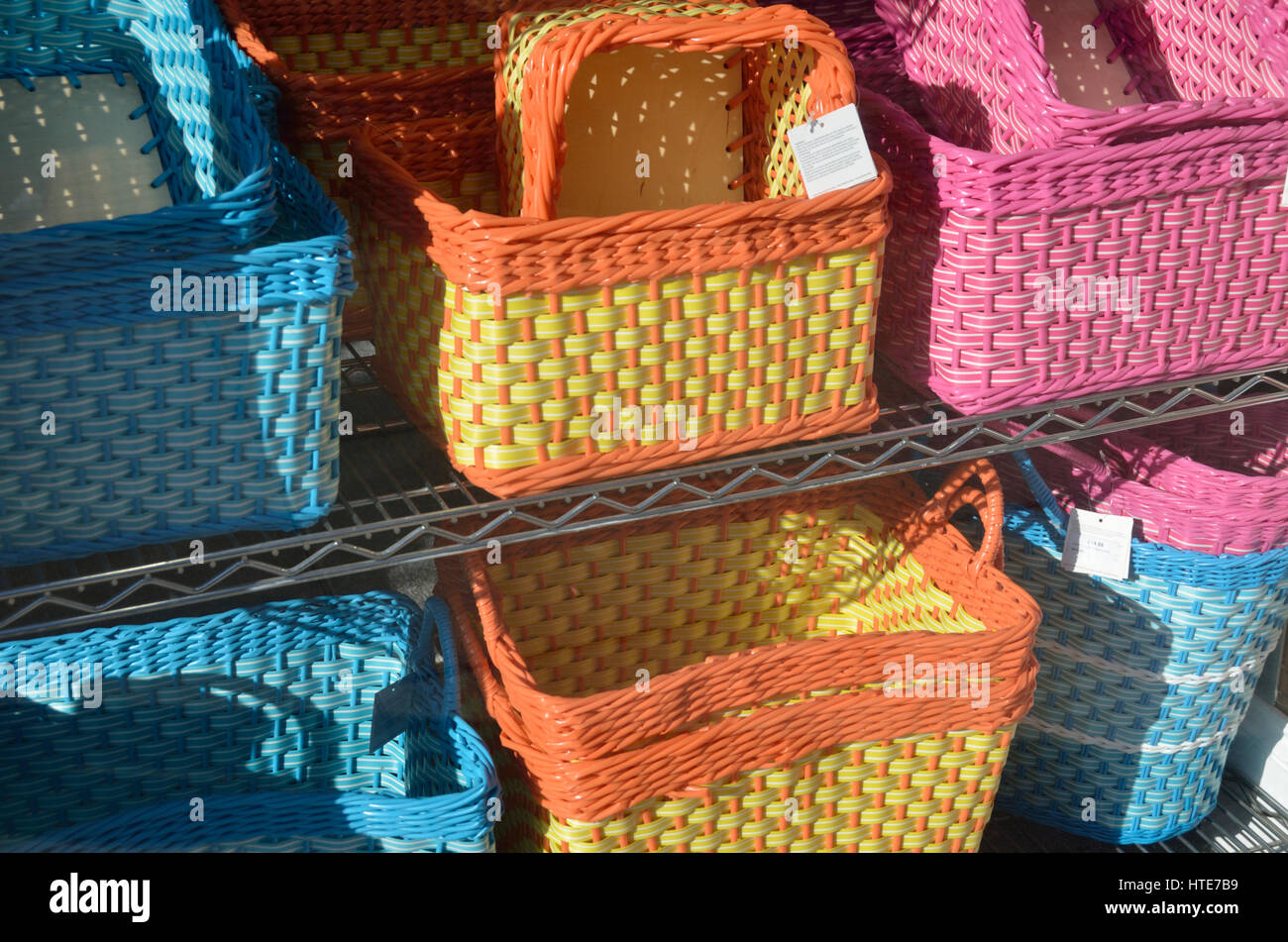 Coloured woven baskets in a shop window display Stock Photo Alamy