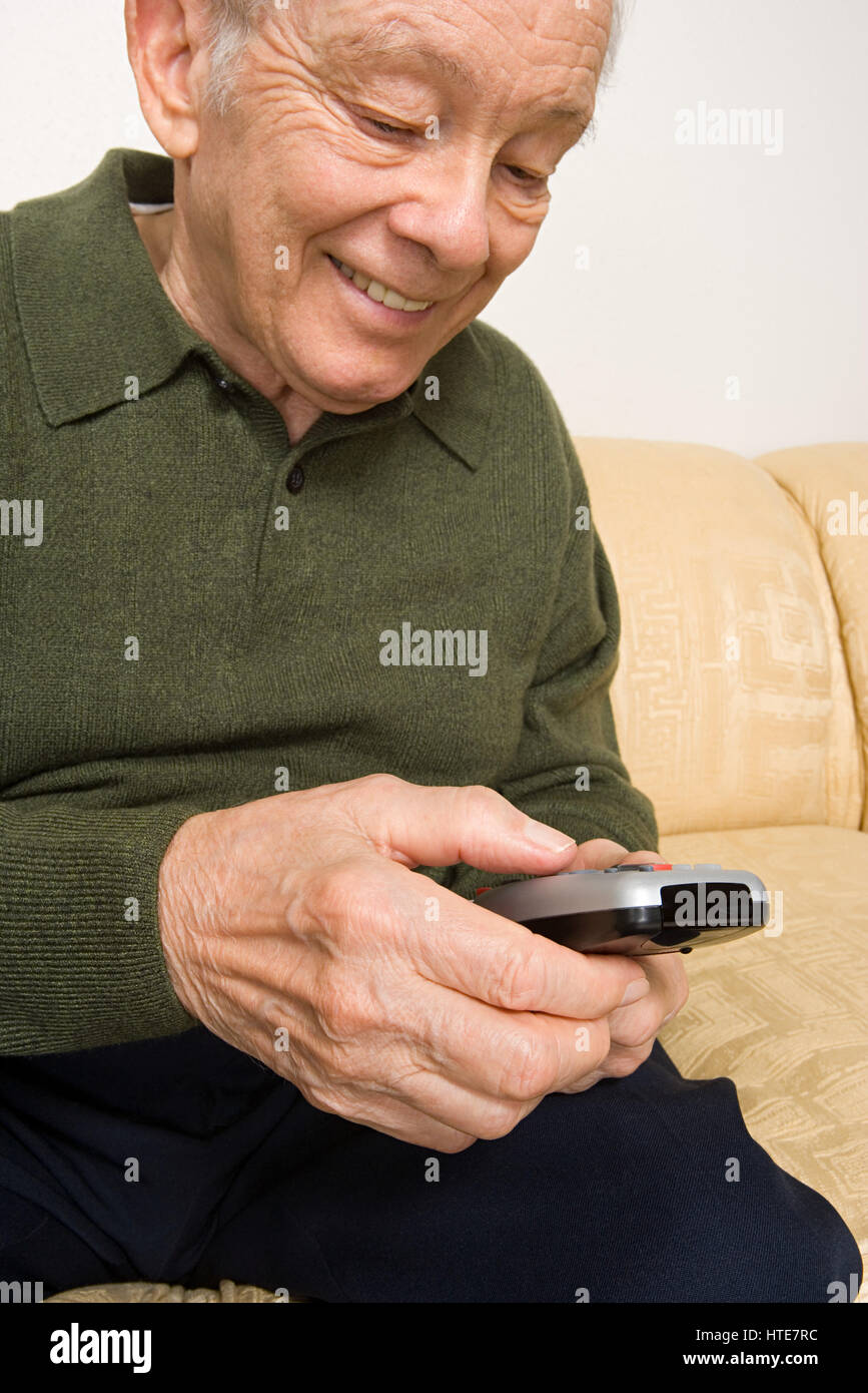 Elderly man with remote control Stock Photo Alamy