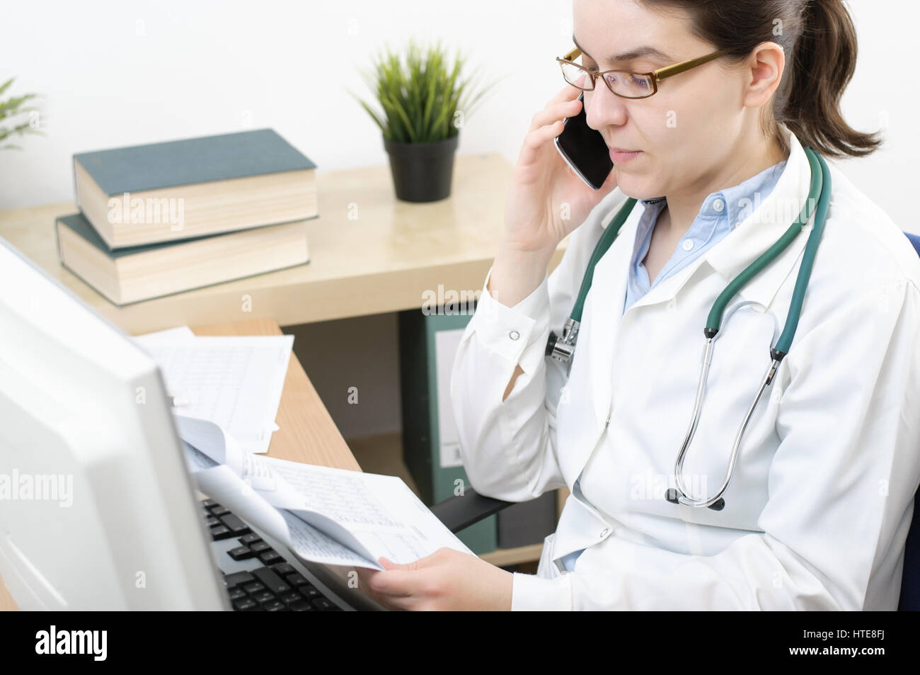 Female doctor talking woman desk hi-res stock photography and images ...