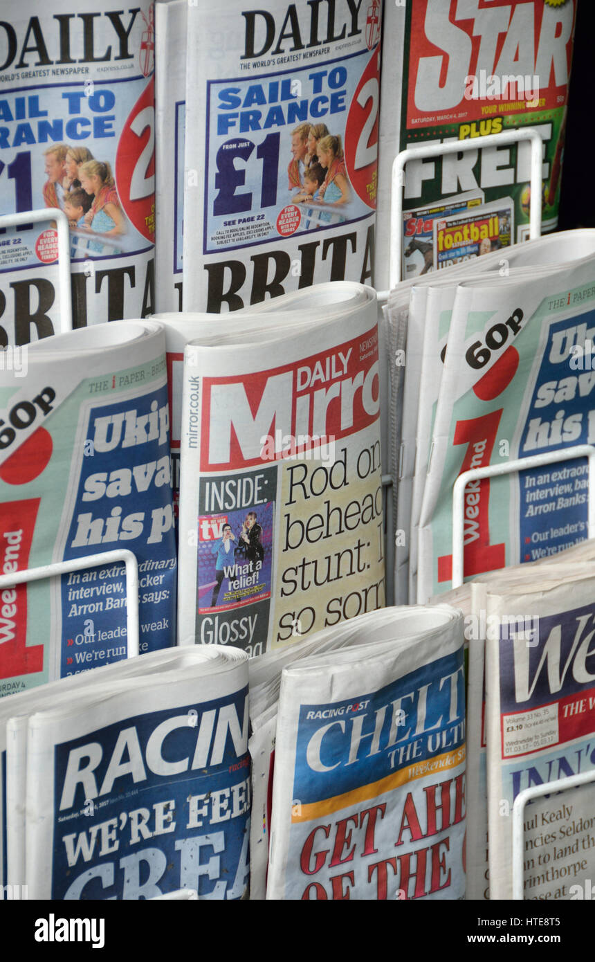 Various UK tabloid newspapers on a newsstand. Stock Photo