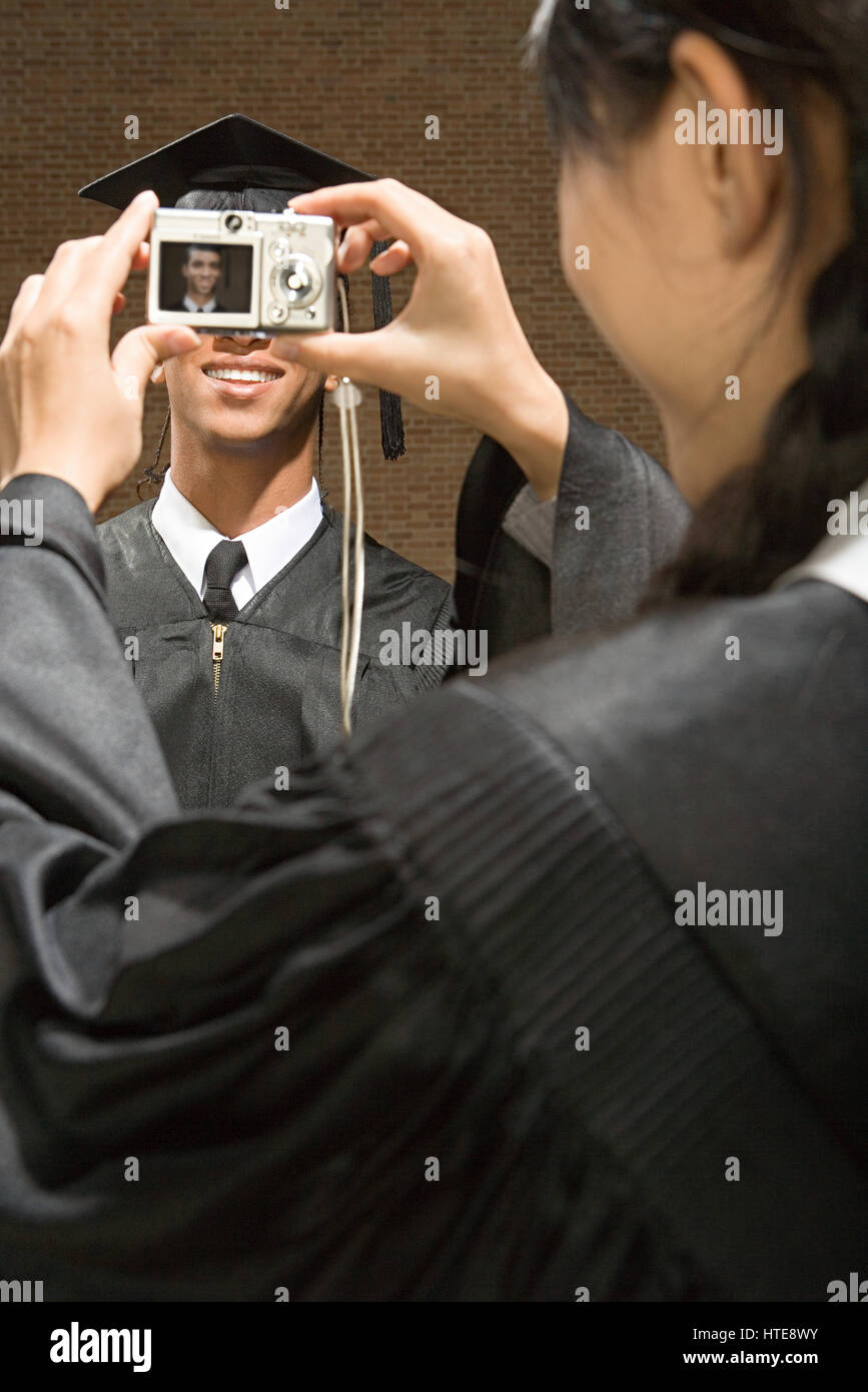 Graduates taking photographs Stock Photo - Alamy