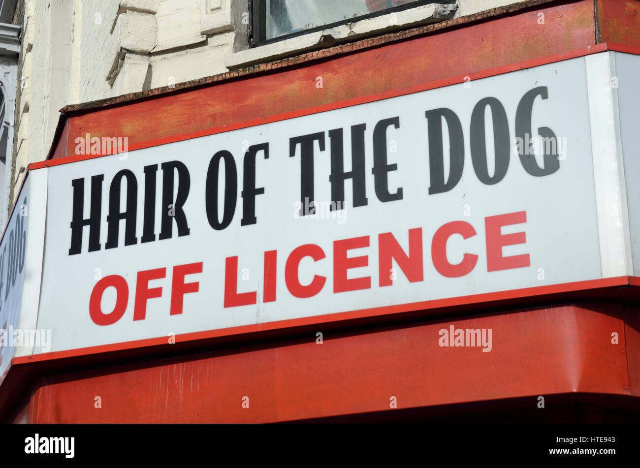 ’Hair of the Dog’ Off Licence sign outside a UK shop. Stock Photo
