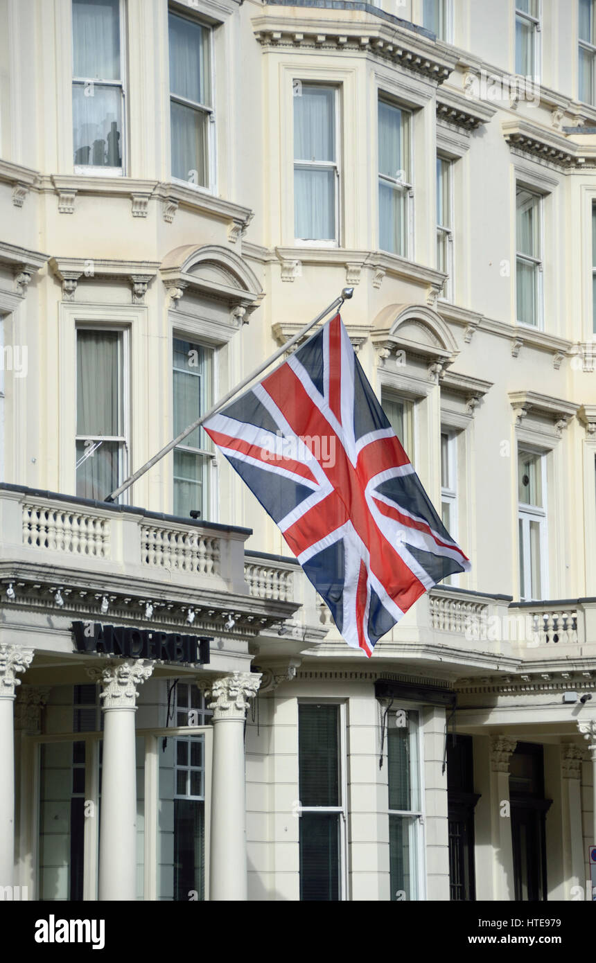 British Union Jack flag outside white stucco Victorian building, Kensington, London, UK. Stock Photo