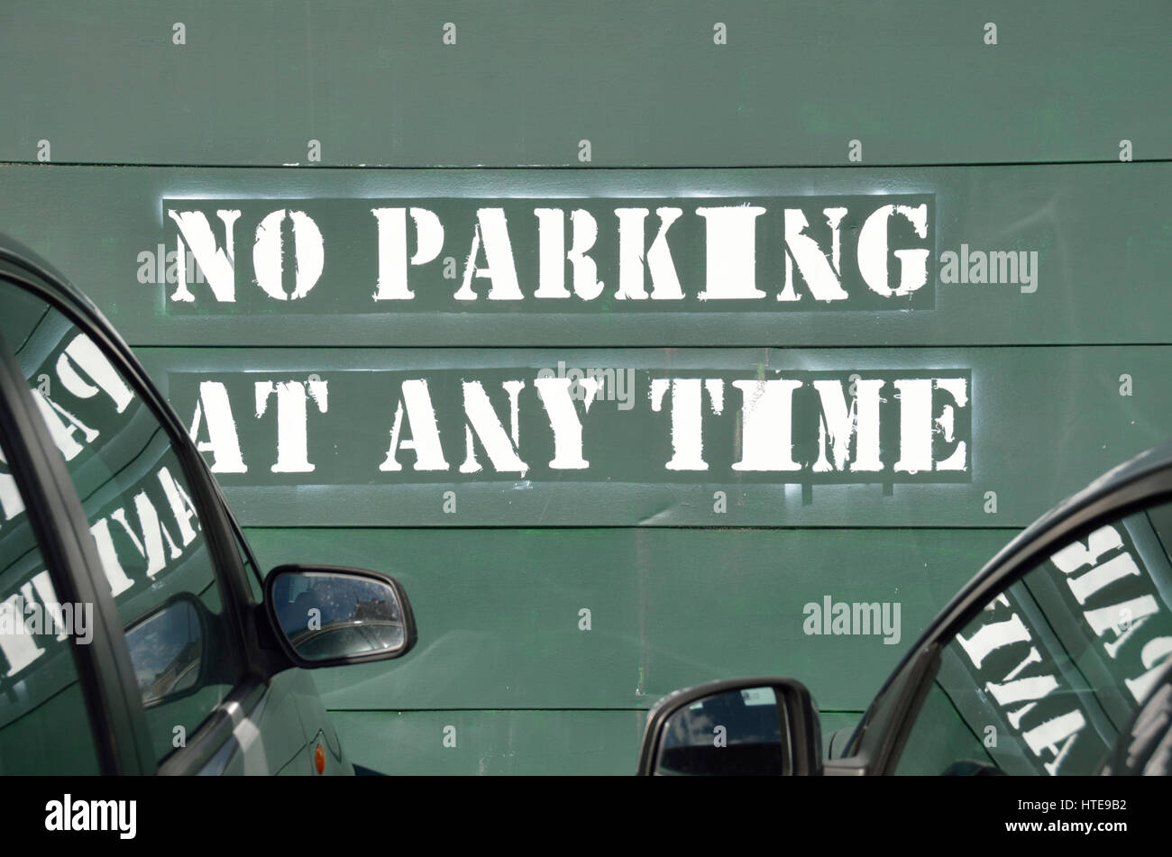 No Parking at Any Time sign on a wall Stock Photo - Alamy