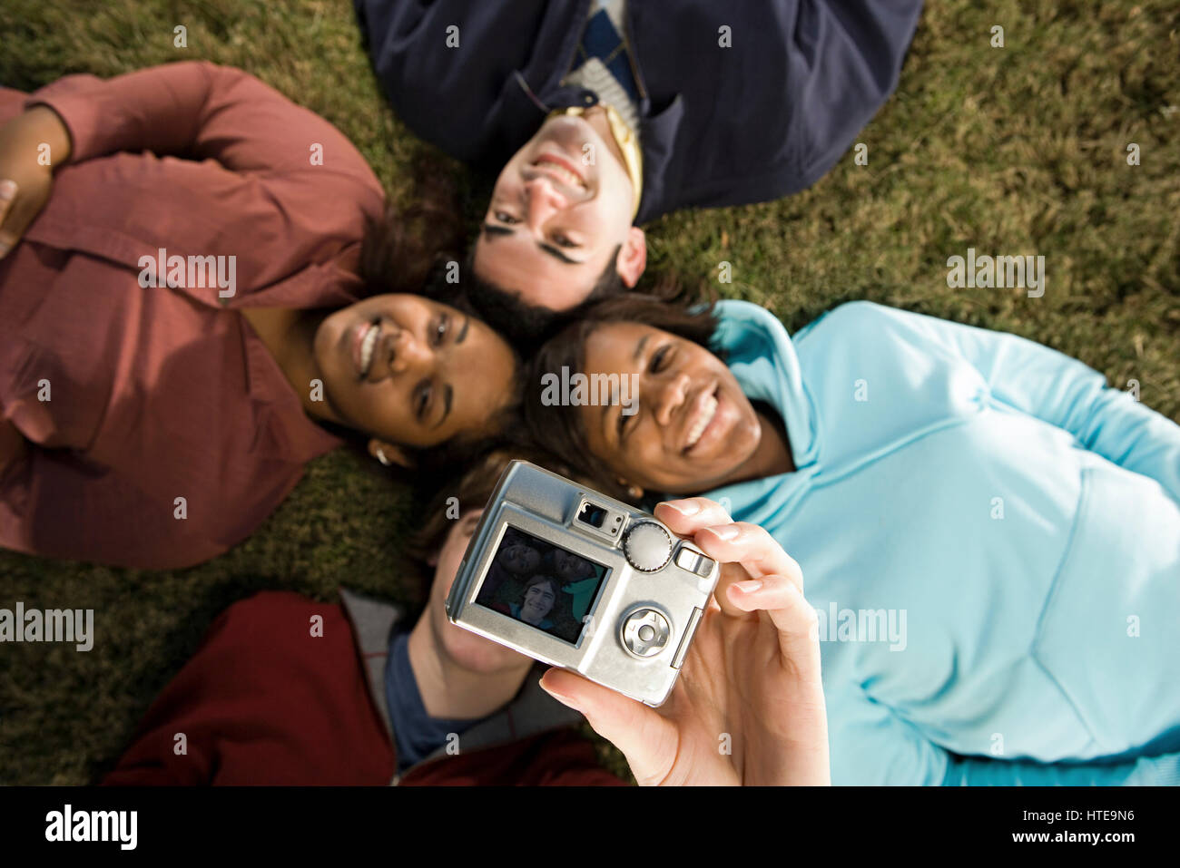 Four students taking a photograph outdoors Stock Photo