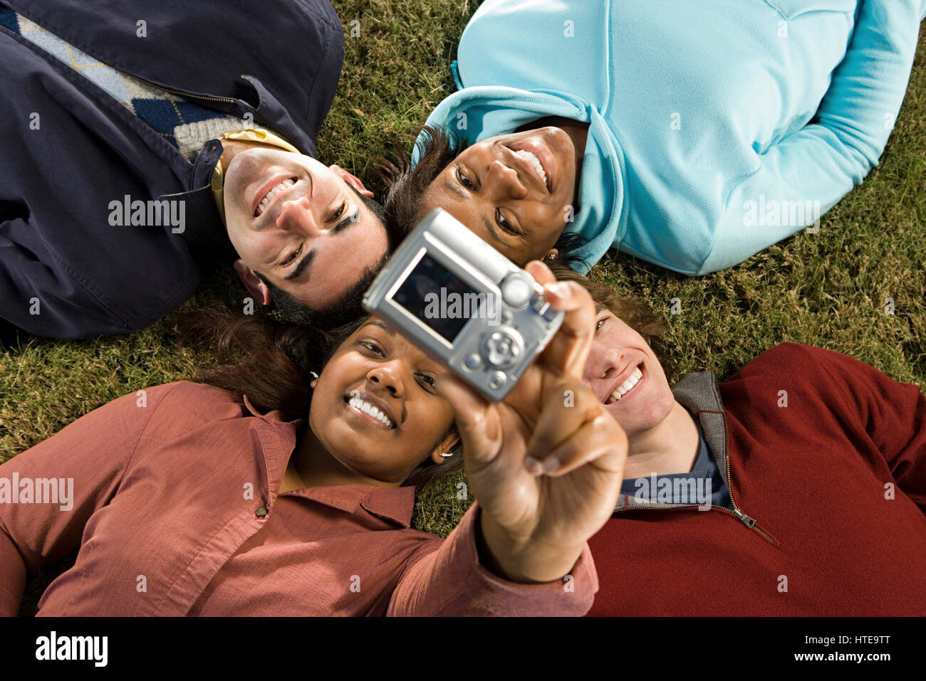 Four students taking a photograph Stock Photo