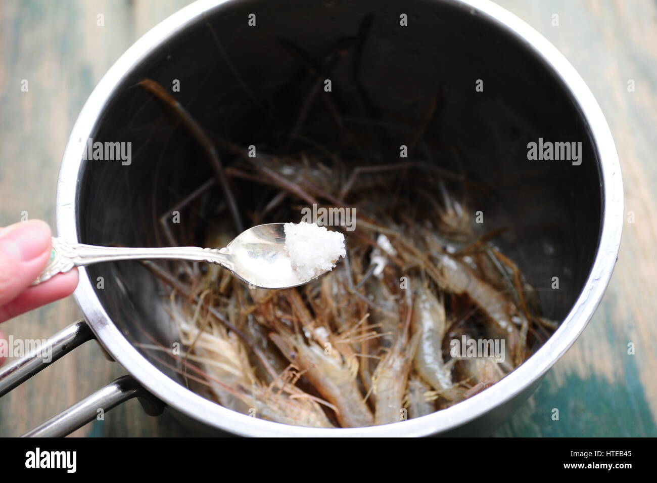 Seasoning fresh shrimp with salt Stock Photo Alamy
