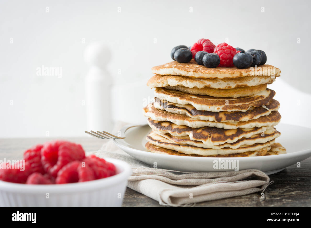 Pancakes with blueberries and raspberries on rustic wood Stock Photo ...