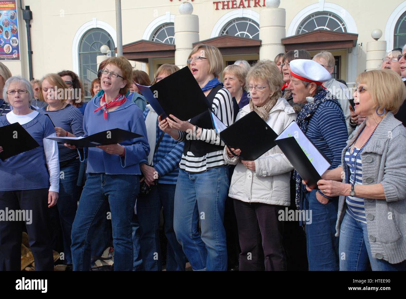 The Soundwaves community choir perform on the seafront at Hastings, England at a fund raising event for the Victorian pier. Stock Photo