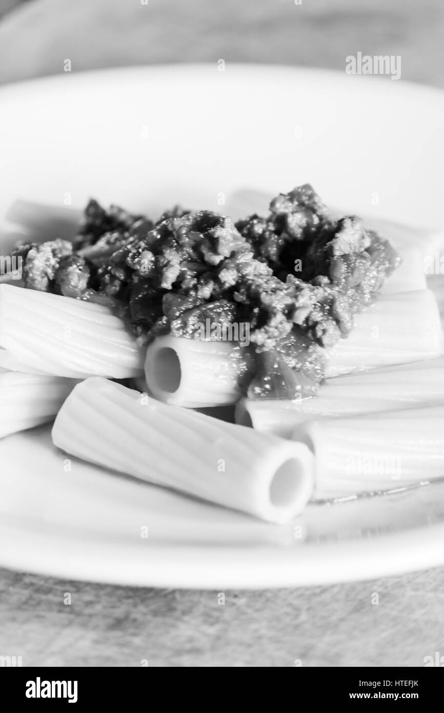 Italian rigatoni pasta with ragù alla bolognese - Black and white Stock Photo