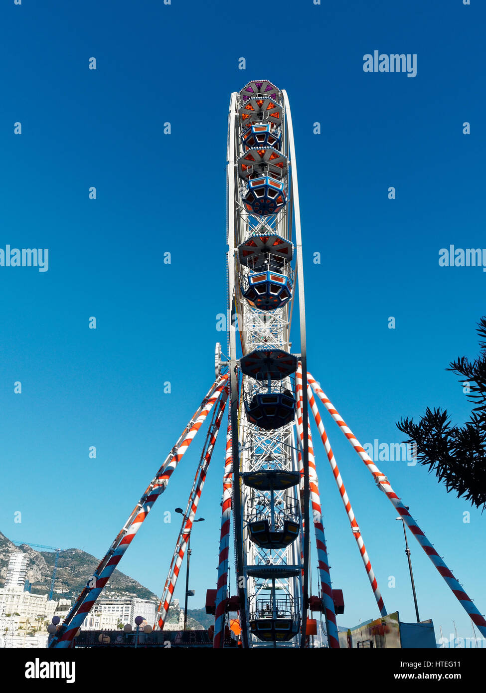 Ferris wheel and ice rink at Port Hercule, behind Hôtel Hermitage Monte-Carlo, Monaco, Mediterranean Stock Photo