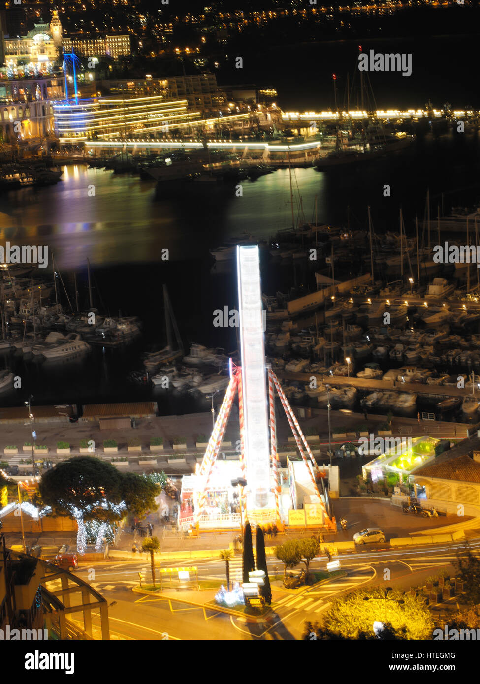 Ferris wheel and ice rink at Port Hercule, behind Hôtel Hermitage Monte-Carlo, Monaco, Mediterranean Stock Photo