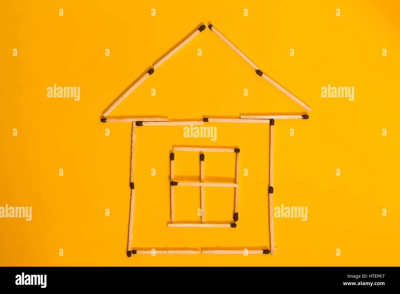 conceptual-picture-is-not-a-big-house-of-matches-on-a-yellow-background