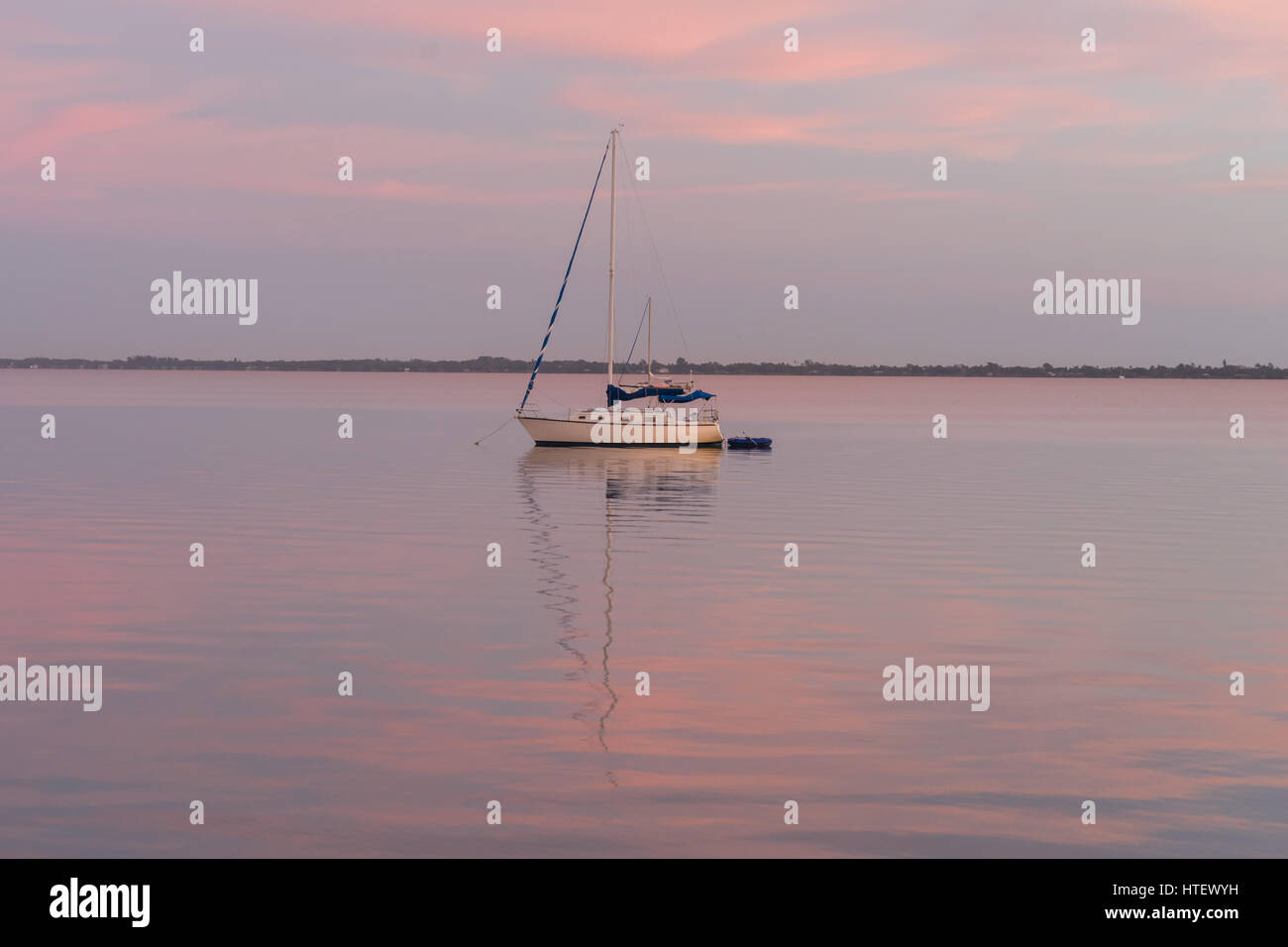 A Sailboat Rests in the Lagoon on an Early Morning in Melbourne, Florida Stock Photo