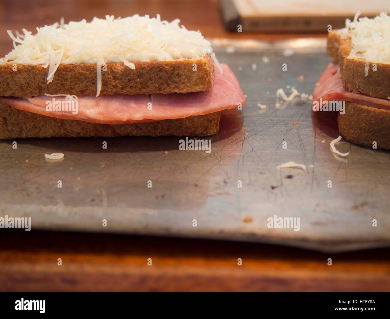Ingredients and making of a croque monsieur French ham and cheese sandwich, toasted, meal, gruyere, Stock Photo