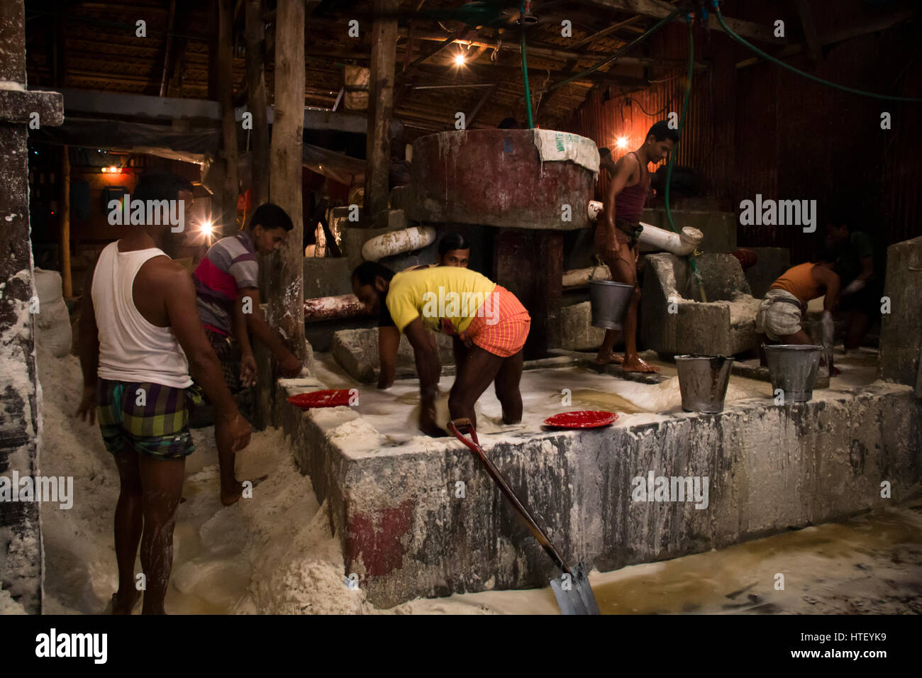CHITTAGONG, BANGLADESH FEBRUARY 2017 Men cleaning salt in a factory