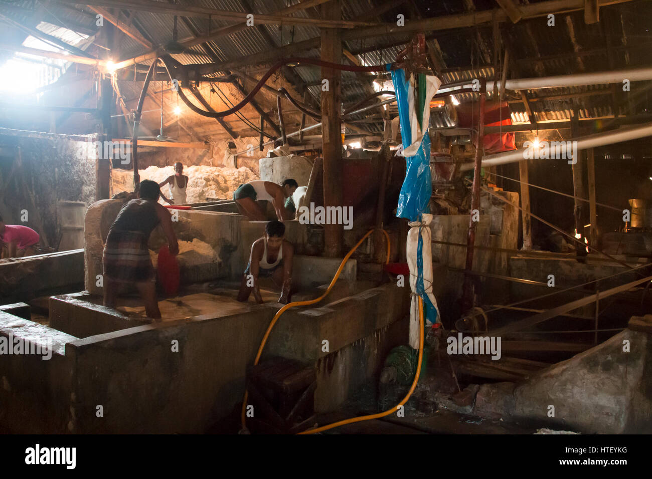 CHITTAGONG, BANGLADESH FEBRUARY 2017 Men cleaning salt in a factory