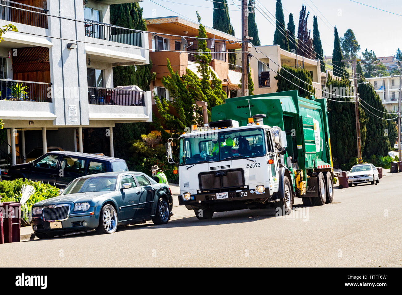 A refuse collection truck picking up Stock Photo