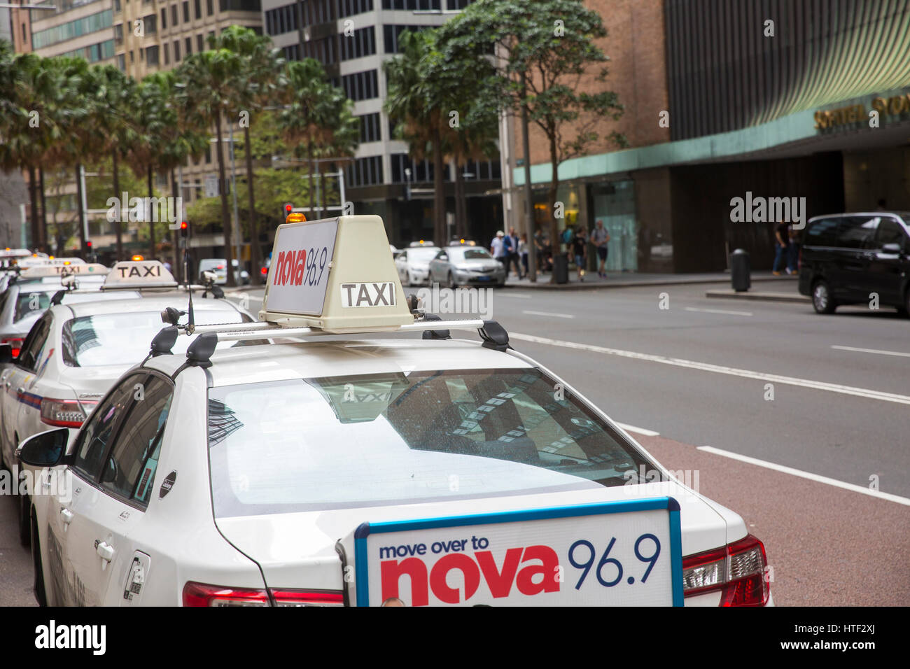 Australian taxi cars waiting in taxi rank in Sydney city centre for customers to hire them,NSW,Australia Stock Photo