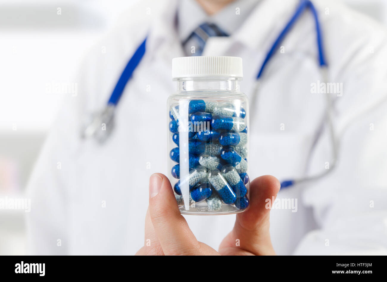 Doctor scientist invented new drug, holds capsule in hands. pill medicine science discovery test formula chemical concept Stock Photo