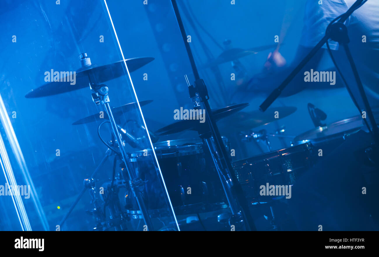 Blue musical photo background, rock drum set on dark stage with cymbals Stock Photo