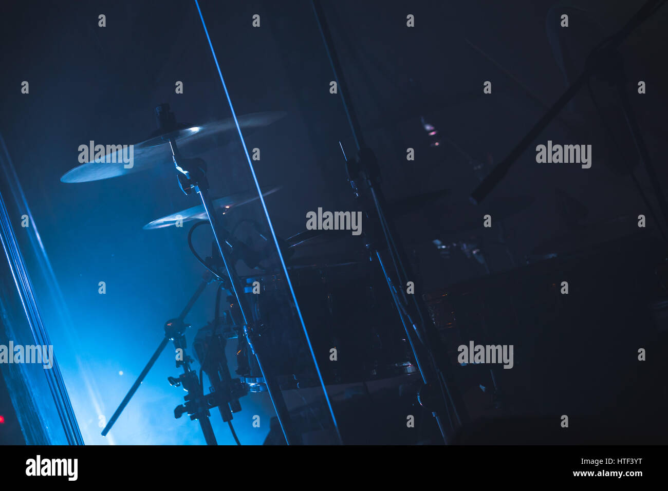 Blue mood musical photo background, rock drum set on dark stage with cymbals Stock Photo