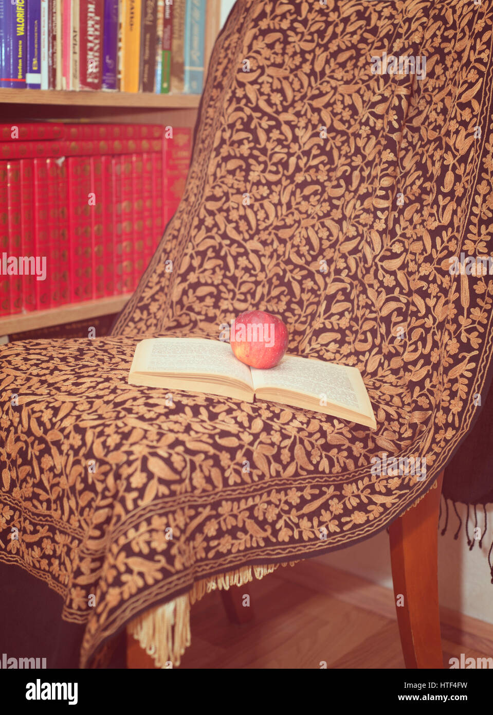 Cozy chair with opened book and a cup Stock Photo