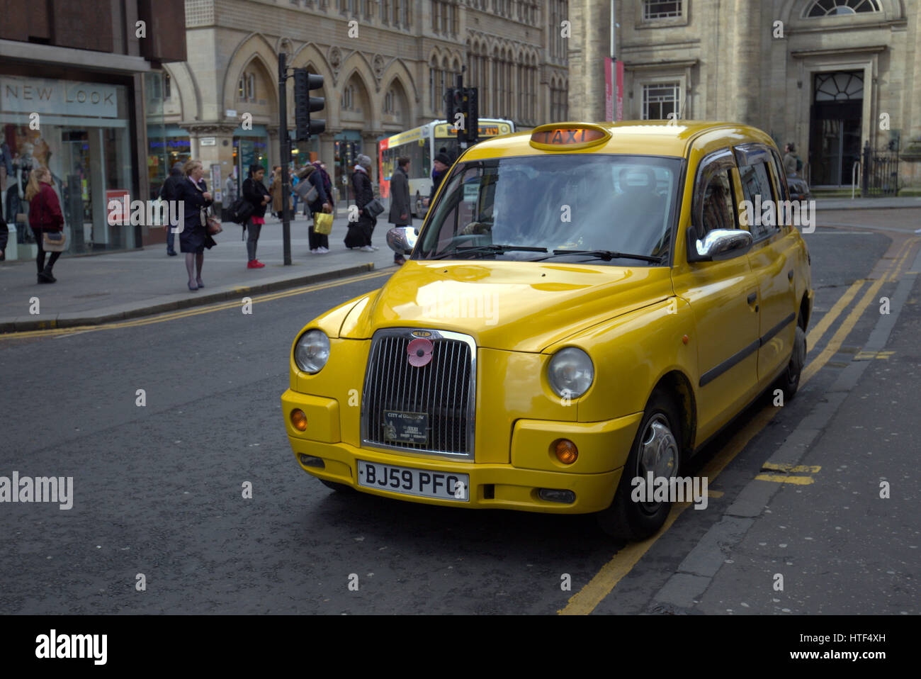 yellow British taxi on Glasgow street Stock Photo