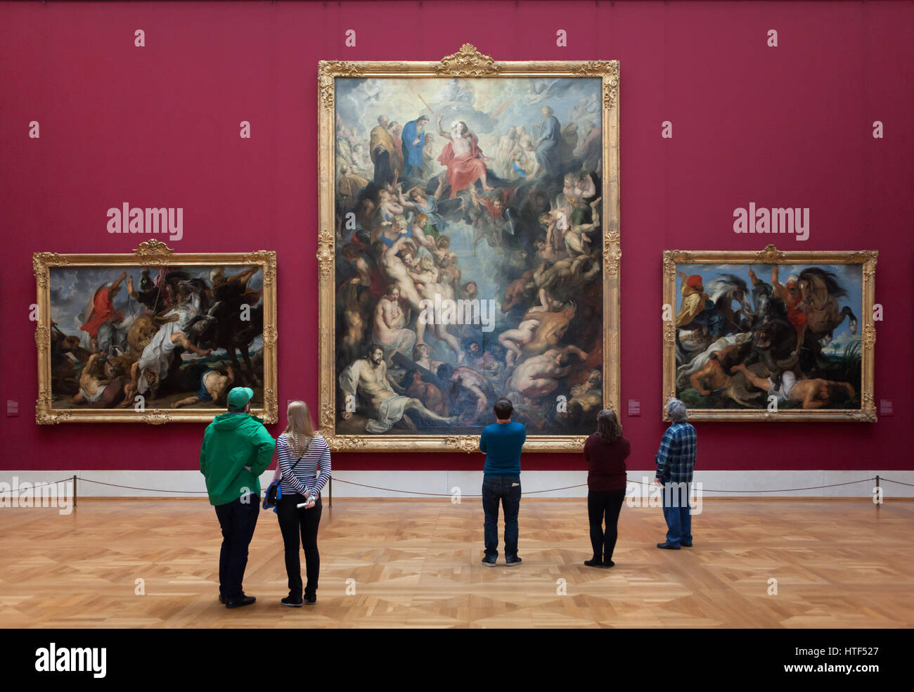 Visitors in front of the paintings by Flemish painter Peter Paul Rubens displayed in the Alte Pinakothek (Old Pinacotheca) in Munich, Bavaria, Germany. Paintings Lion Hunt (1621), The Great Last Judgement (1617) and The Hippopotamus and Crocodile Hunt (1616) by Peter Paul Rubens are depicted from left to right. Stock Photo