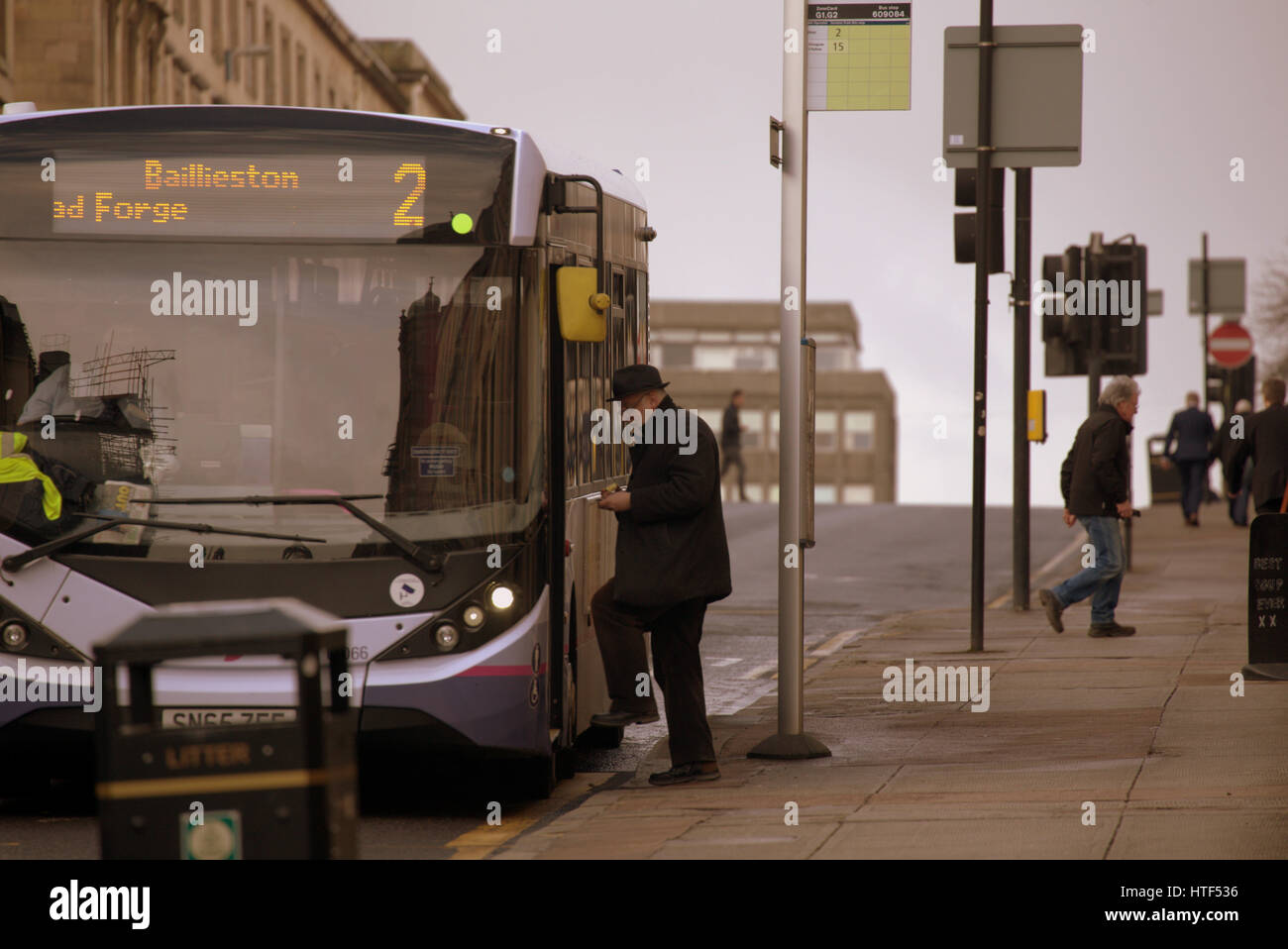 man boarding firstbus bus glasgow Stock Photo