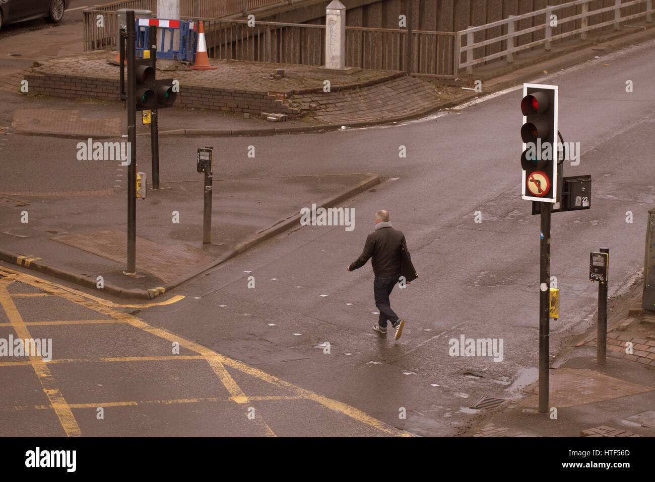 Glasgow City cityscape street scene crossing road at traffic lights young guy Stock Photo