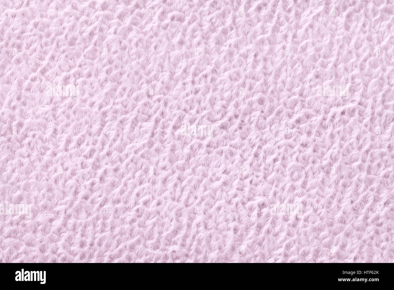 Light pink fluffy background of soft fleecy cloth texture of textile