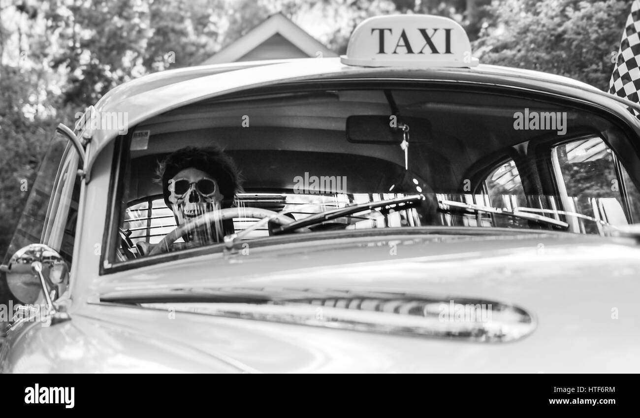 Skeleton driving a taxi cab Stock Photo