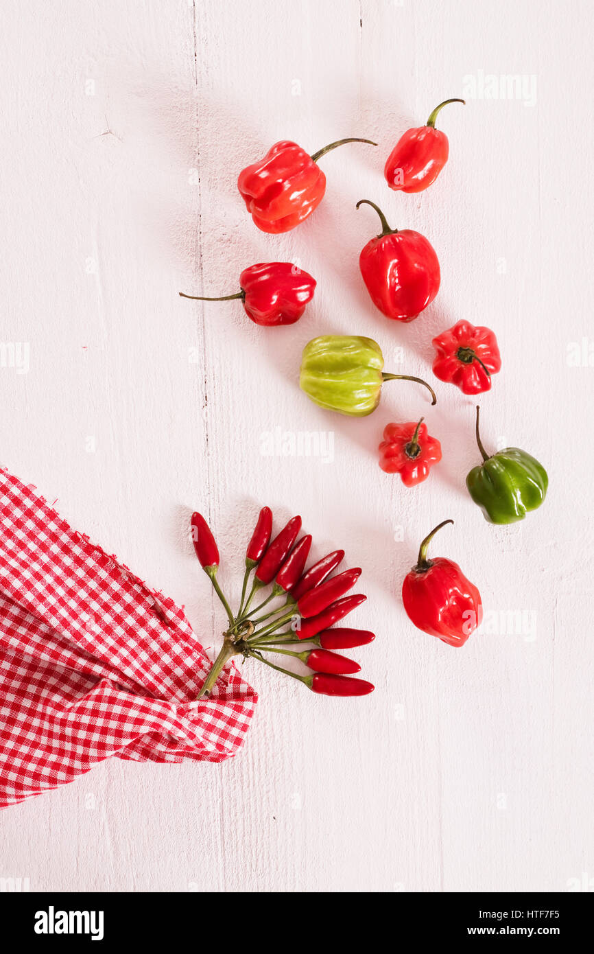 Red hot chili peppers on wooden table Stock Photo - Alamy