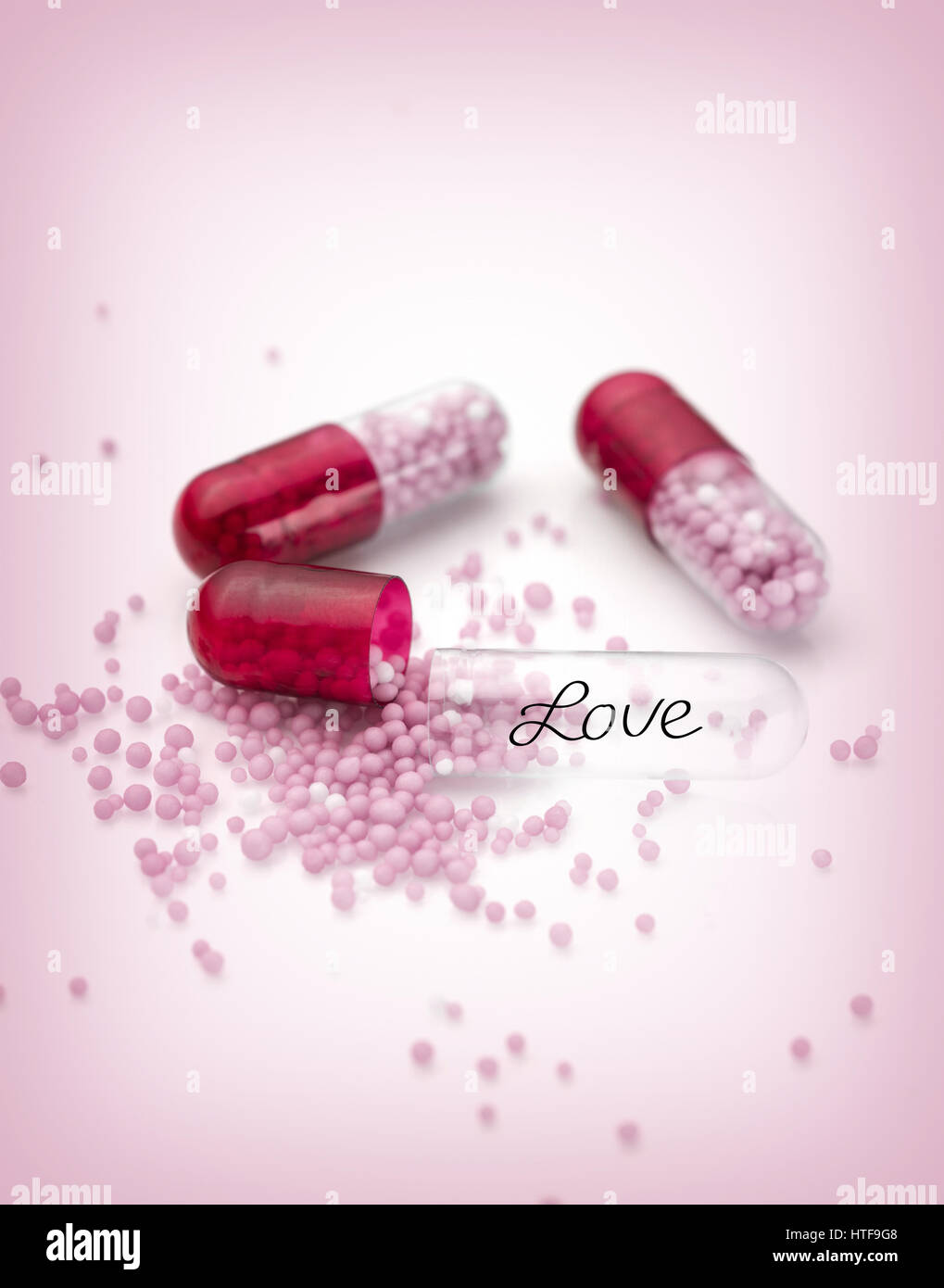 The Pink capsules and pills conceptual background Stock Photo - Alamy