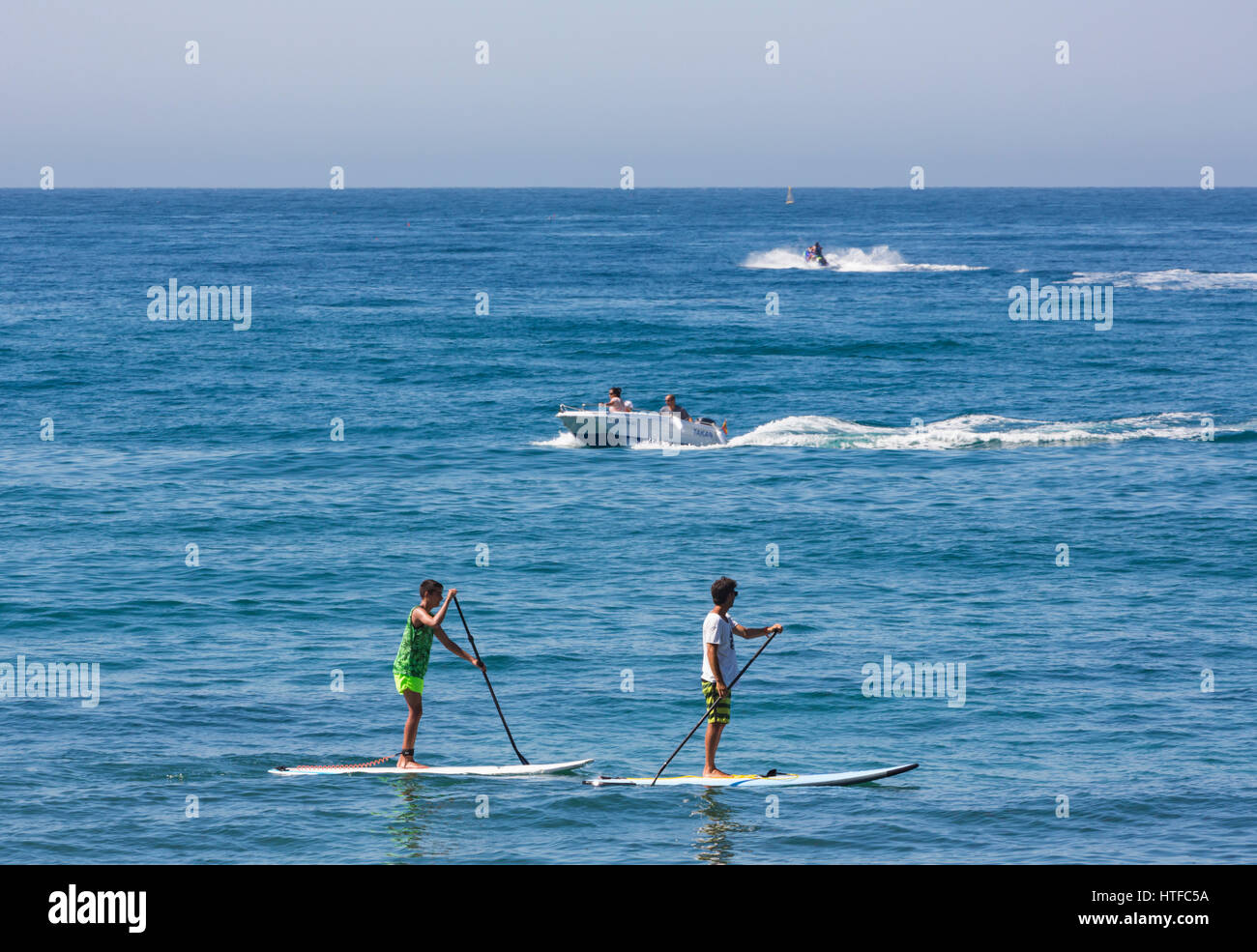 Marbella, Costa del Sol, Malaga Province, Andalusia, southern Spain. Group practicing standup paddle boarding. Stock Photo