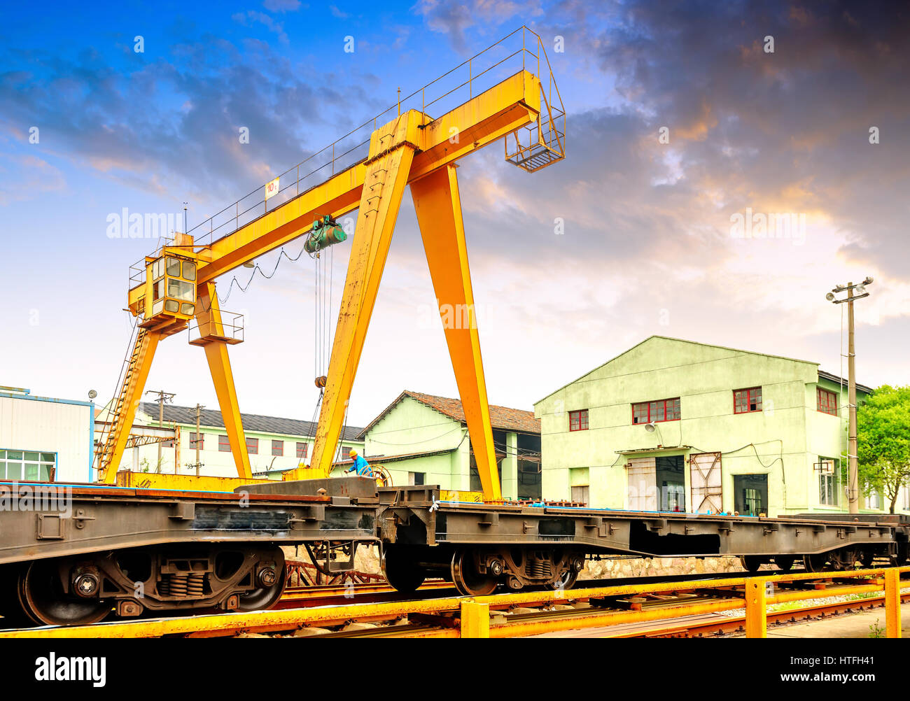 Pier bridge crane and cargo handling, cargo trains transported away. Stock Photo