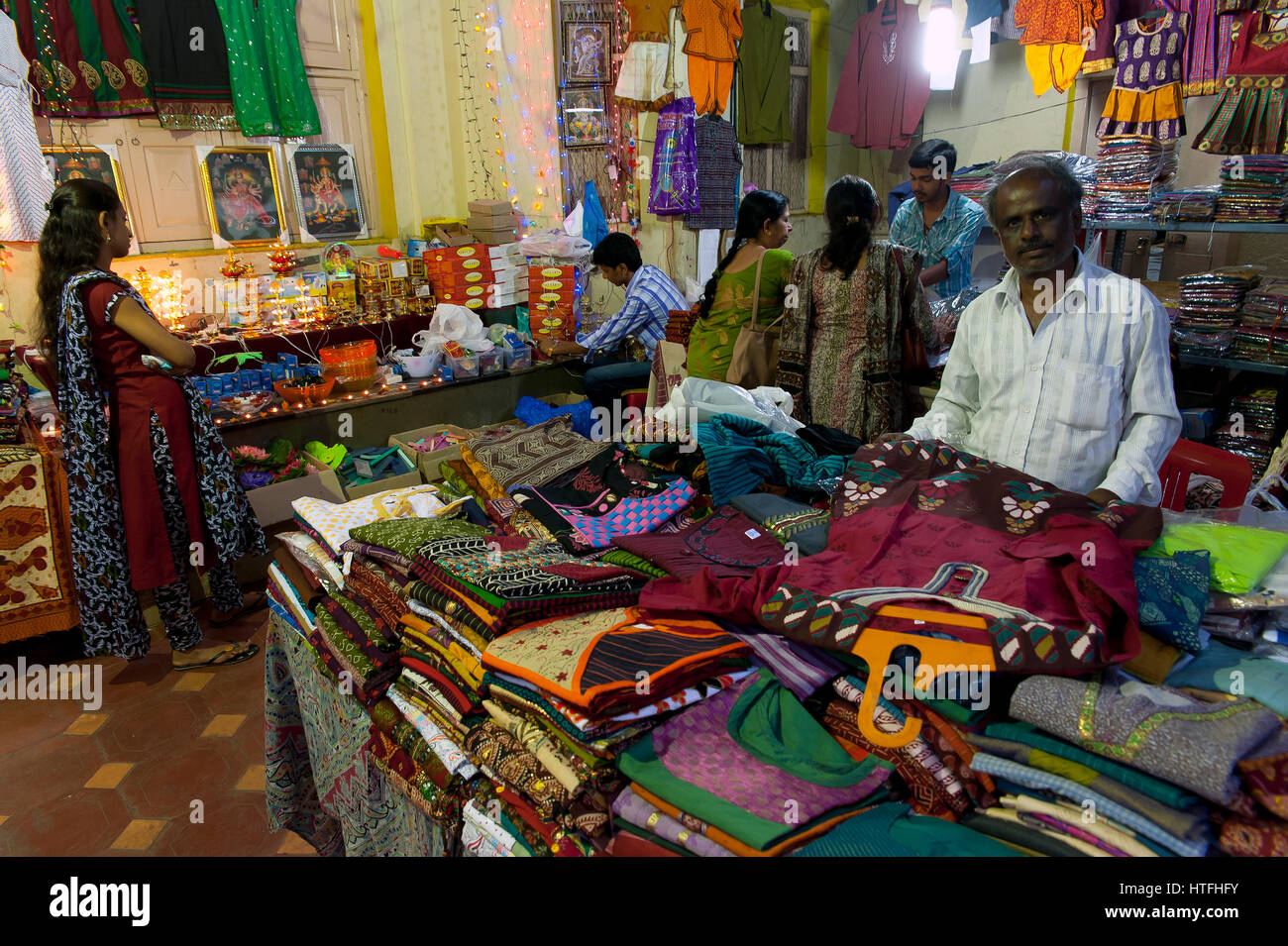 Clothes seller at his shop, Bangalore, Karnataka, India Stock Photo