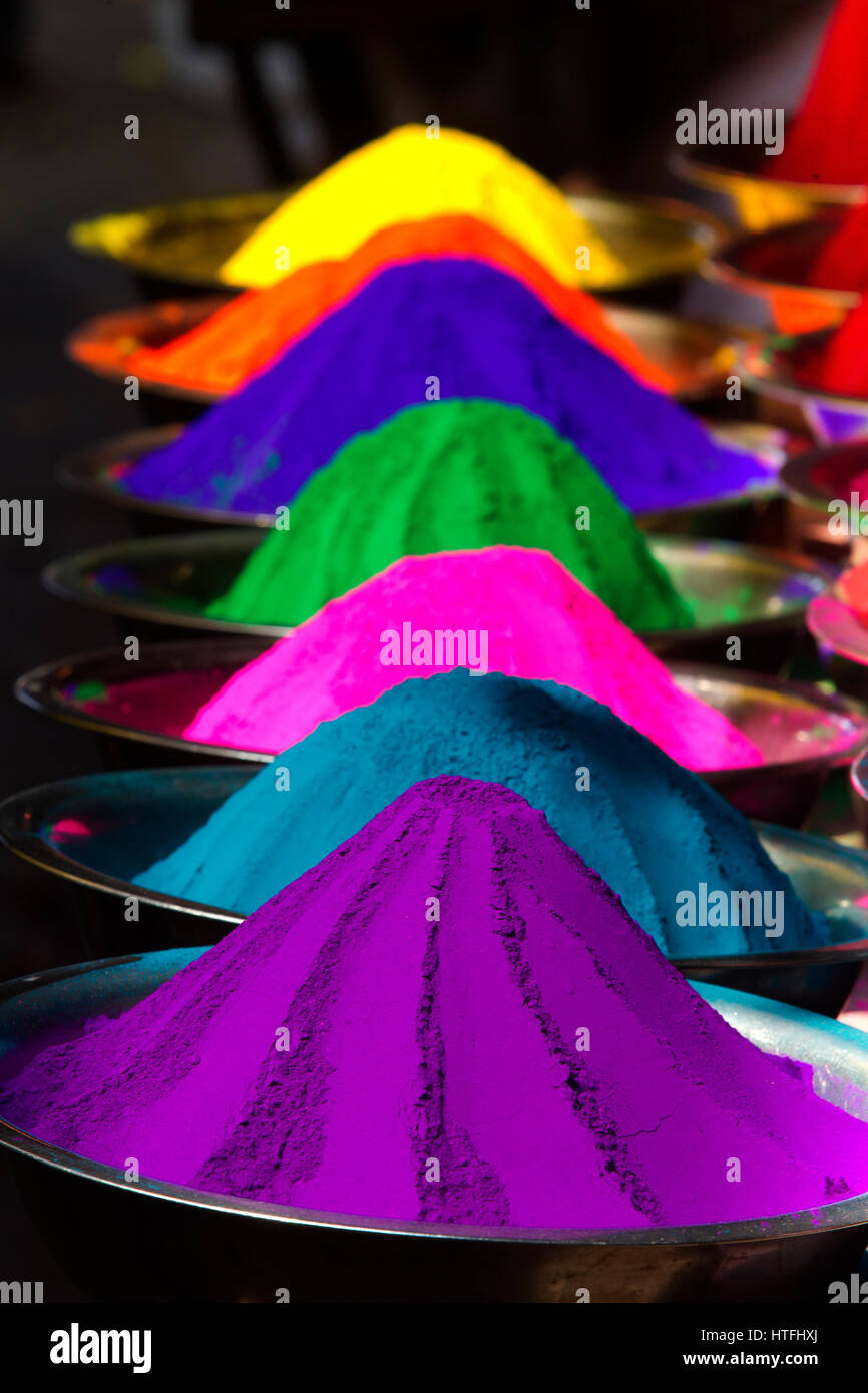 Sticker Colorful piles of holi powder dye at mysore market
