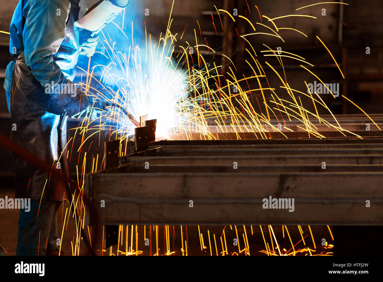 Workers at work, ongoing welding operation. Stock Photo