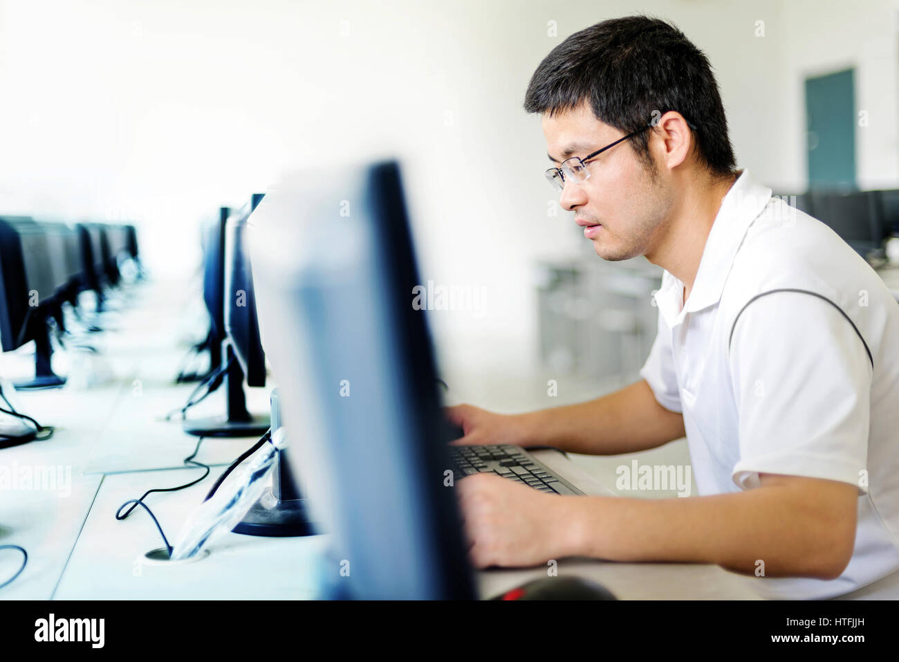 Asian man in front of the computer work Stock Photo - Alamy