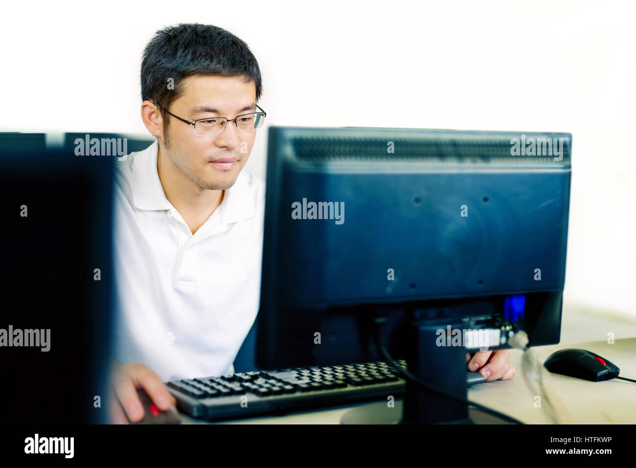 Asian man in front of the computer work Stock Photo - Alamy