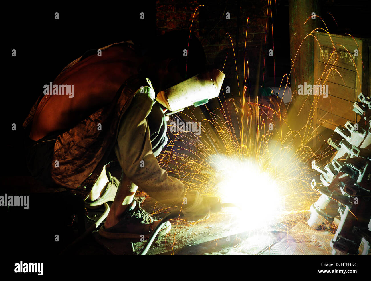Workers at work, ongoing welding operation. Stock Photo